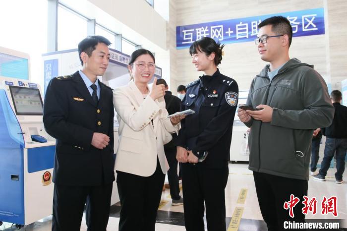 4月10日，安徽合肥，一家運輸企業(yè)負責人在工作人員的指導下，使用小程序辦理車管業(yè)務?！『戏示焦﹫D