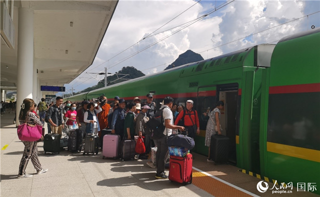 乘坐中老鐵路國(guó)際旅客列車的旅客在老撾瑯勃拉邦站排隊(duì)上車。人民網(wǎng)記者 杜明明攝