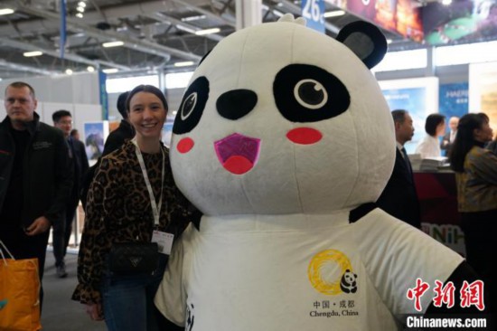 3月5日，2024年柏林國際旅游交易會(ITB)在柏林會展中心拉開帷幕。以“你好！中國”為主題的中國展區(qū)當日亮相展會。圖為觀眾與大熊貓人偶合影。中新社記者 馬秀秀 攝