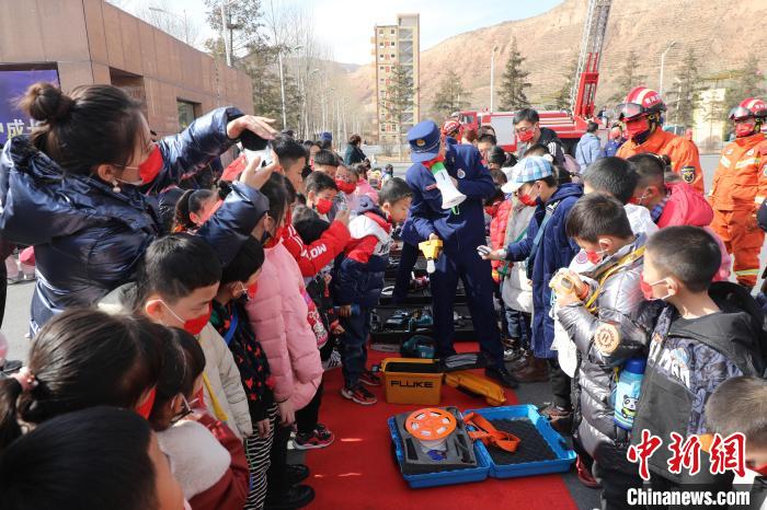 圖為小朋友們聽消防員講解消防器材?！铨埥?攝